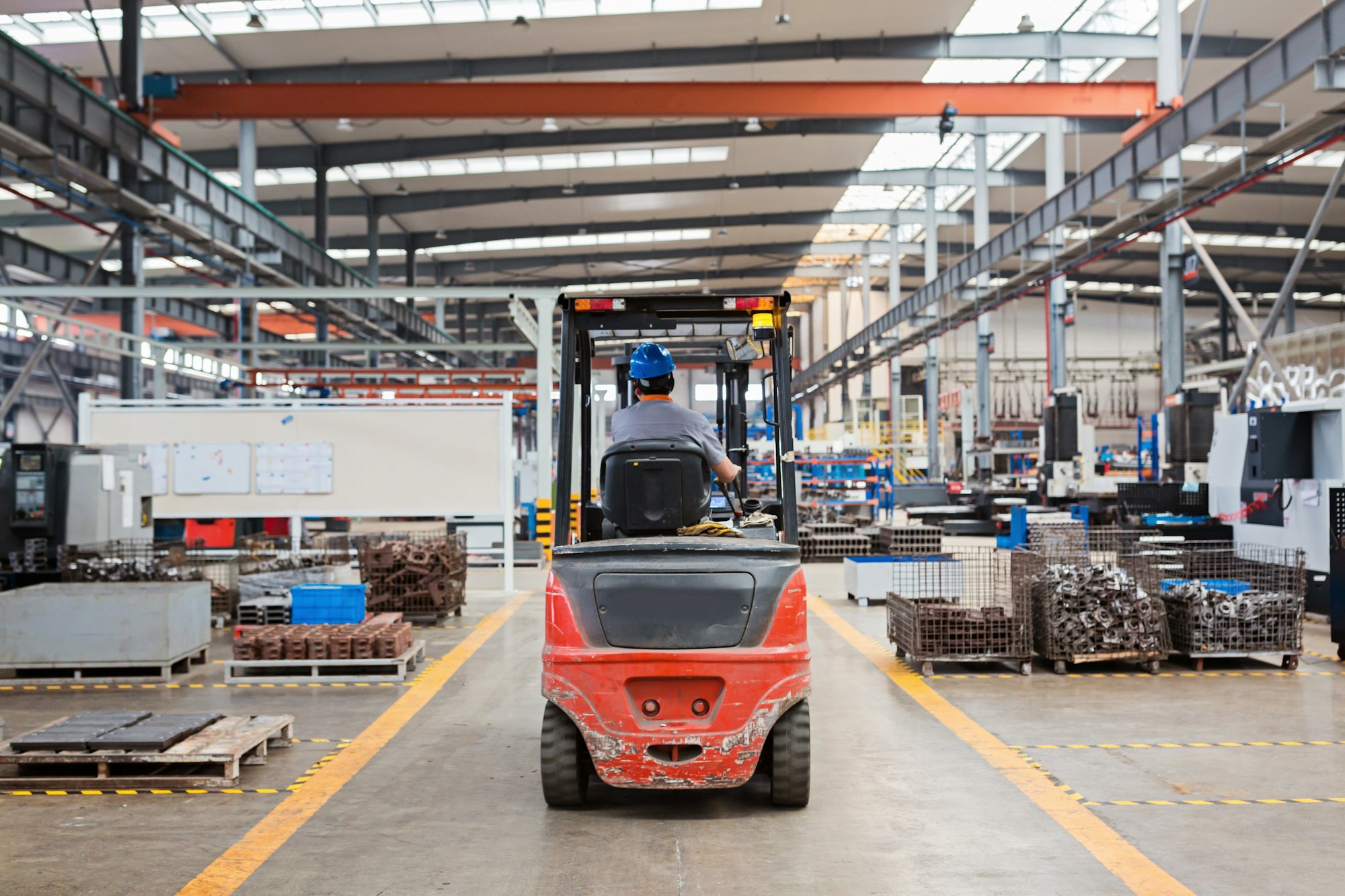 Employee in forklift working on modern factory